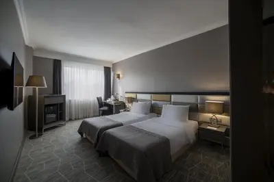 a hotel room with a bed and a desk at Taksim Square Hotel in Istanbul