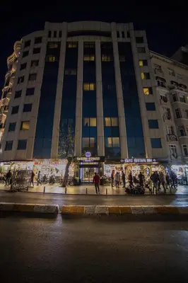 a large building with people walking in front of it at Taksim Square Hotel in Istanbul