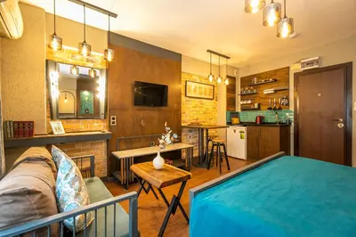 a living room with a couch and a kitchen at Cube Suites in Istanbul