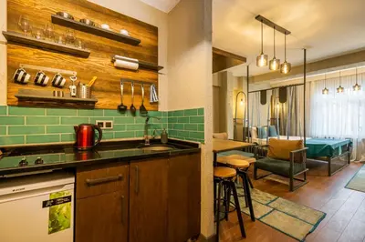 a kitchen with a sink and a living room at Cube Suites in Istanbul