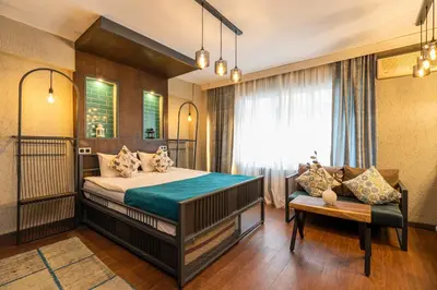 a bedroom with a large bed and a couch at Cube Suites in Istanbul