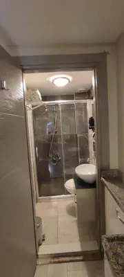 a bathroom with a shower and a toilet and a sink at Ortaköy Suites Hotel in Istanbul