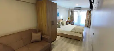 a bedroom with a bed and a couch in a room at Ortaköy Suites Hotel in Istanbul