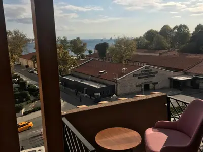 a balcony with a chair and a view of a street at Meydan Besiktas Hotel in Istanbul