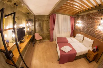 a bedroom with a bed and a desk and a chair at Meydan Besiktas Hotel in Istanbul