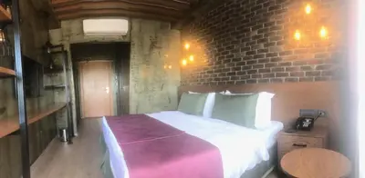 a bedroom with a large bed in a brick wall at Meydan Besiktas Hotel in Istanbul