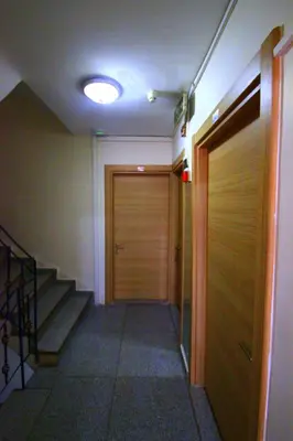 a hallway with a wooden door and a staircase at Istanbul Metro Hotel in Istanbul