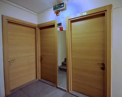 two wooden doors in a hallway in a building at Istanbul Metro Hotel in Istanbul