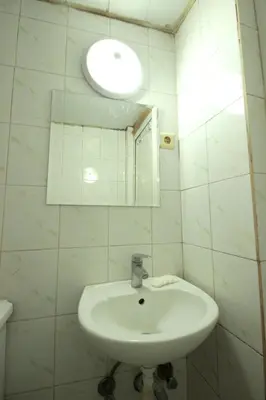 a white bathroom with a sink and a mirror at Istanbul Metro Hotel in Istanbul