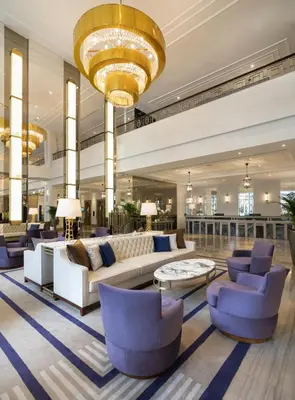 a lobby with couches and chairs and a chandelier at Barceló Istanbul in Istanbul
