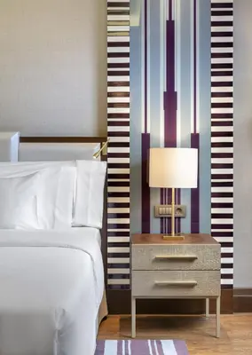 a bedroom with a bed and a table with a lamp at Barceló Istanbul in Istanbul