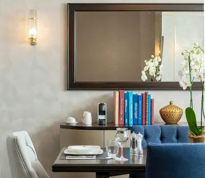 a dining room with a table and a blue chair at Barceló Istanbul in Istanbul