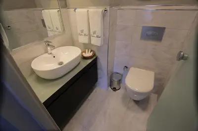 a bathroom with a sink and a toilet at Ferman Pera Hotel in Istanbul
