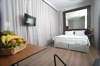 a hotel room with a bed and a basket of fruit at Ferman Pera Hotel in Istanbul