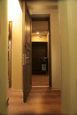 an open door leading to a hallway with a room at Ferman Pera Hotel in Istanbul