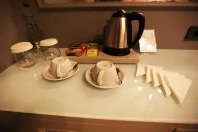 a table with two plates and a tea kettle at Royal Tophane in Istanbul