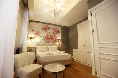 a bedroom with a bed and a chair and a table at Royal Tophane in Istanbul