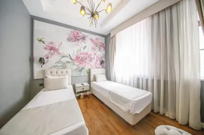 a bedroom with two beds and a floral mural at Royal Tophane in Istanbul