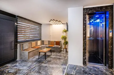 a lobby with a shower and a bench and a table at The Queen Hotel in Istanbul