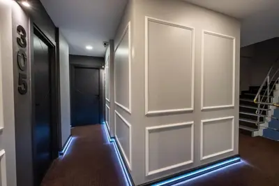 a door leading into a hallway with a staircase at The Queen Hotel in Istanbul