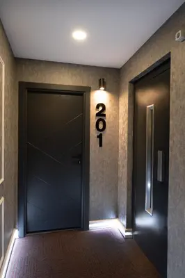 a door with the number eight on the wall at The Queen Hotel in Istanbul