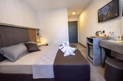 a hotel room with a bed with a towel on it at The Queen Hotel in Istanbul
