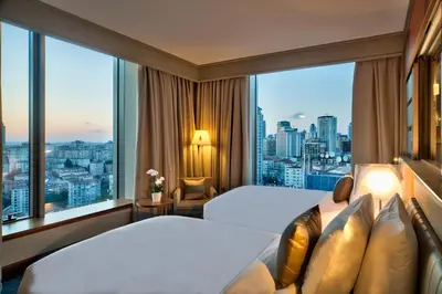 a hotel room with two beds and a large window at Renaissance Istanbul Polat Bosphorus Hotel in Istanbul