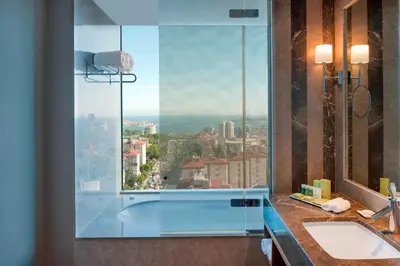 a bathroom with two sinks and a large window at Renaissance Istanbul Polat Bosphorus Hotel in Istanbul