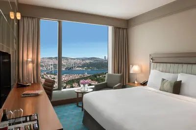 a hotel room with a bed and a large window at Renaissance Istanbul Polat Bosphorus Hotel in Istanbul