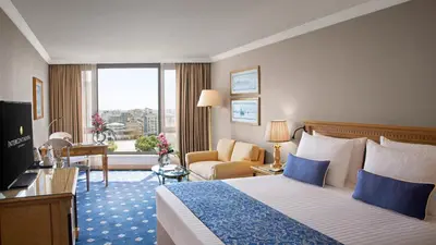 a hotel room with a bed and a desk and a window at InterContinental Istanbul by IHG in Istanbul