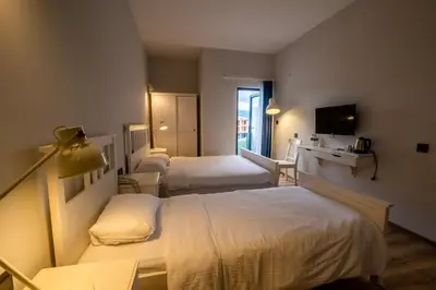 a hotel room with two beds and a television at Eleia Hotel İznik in Bursa