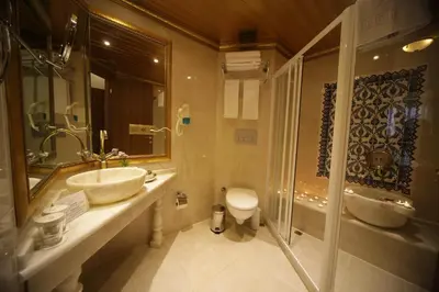 a bathroom with a sink and a toilet at Marmara Deluxe Hotel in Istanbul