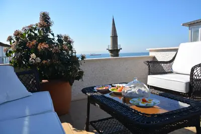 a balcony with a table with plates of food on it at Dilhayat Kalfa Hotel in Istanbul