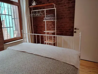 a bedroom with a bed and a brick wall at Kunterbunt Istanbul in Istanbul