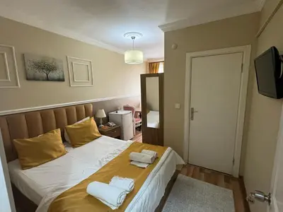 a bedroom with a bed with two towels on it at NEW BEYLERBEYİ HOTEL in Istanbul