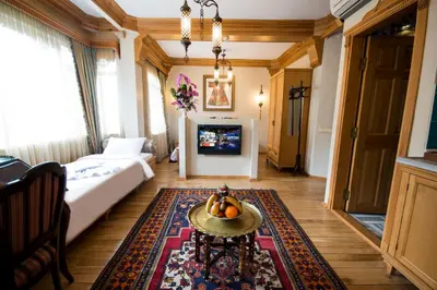 a living room with a bed and a table with fruit on it at Sultan Corner Hotel in Istanbul