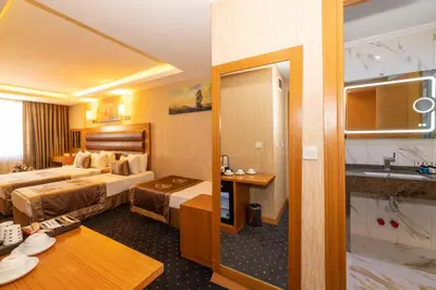 a hotel room with two beds and a bathroom at Regno Hotel in Istanbul