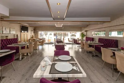 a restaurant with tables and chairs in a room at Regno Hotel in Istanbul