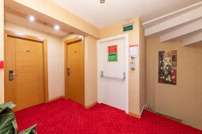 a hallway with two doors and a red carpet at Regno Hotel in Istanbul