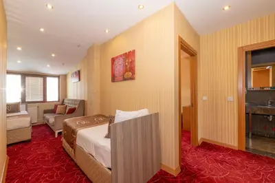 a hotel room with a bed and a living room at Regno Hotel in Istanbul