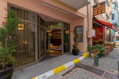 a building with a yellow and white stripe on the street at Feri Suites in Istanbul