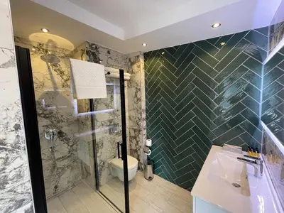 a bathroom with a shower and a sink and a toilet at Feri Suites in Istanbul