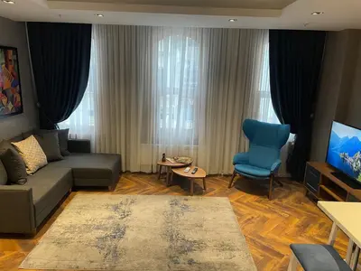 a living room with a couch and a blue chair at Feri Suites in Istanbul