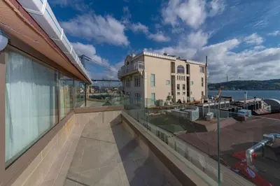 a balcony with a view of a building and the water at Feri Suites in Istanbul