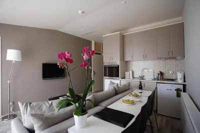 a living room with a couch and a table with flowers at Home Stay Home Sisli in Istanbul