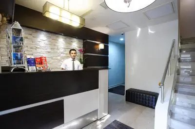 a man standing behind a bar in a lobby at Home Stay Home Sisli in Istanbul