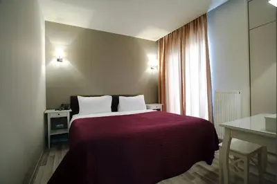 a bedroom with a bed with a red blanket and a window at Home Stay Home Sisli in Istanbul