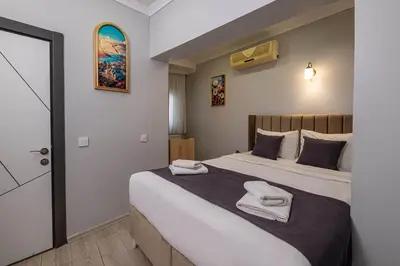 a bedroom with a large bed with towels on it at Family Istanbul Hotel in Istanbul
