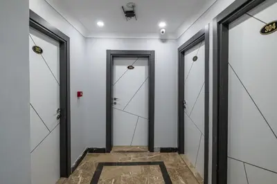 a corridor with doors and a tile floor at Family Istanbul Hotel in Istanbul
