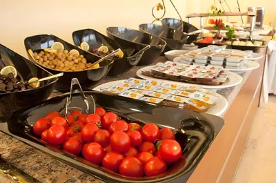 a buffet of food with tomatoes and other foods at Abel Hotel in Istanbul